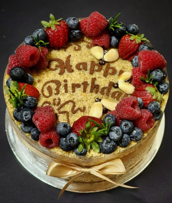 Honey cake with walnut crumbs, berries and 3 bees